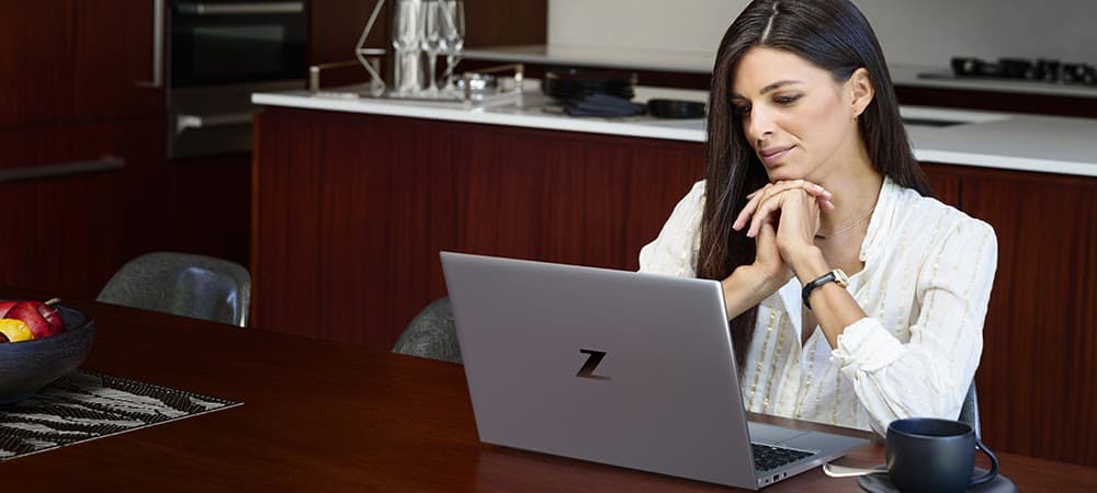 Woman Sitting in Front of HP Laptop